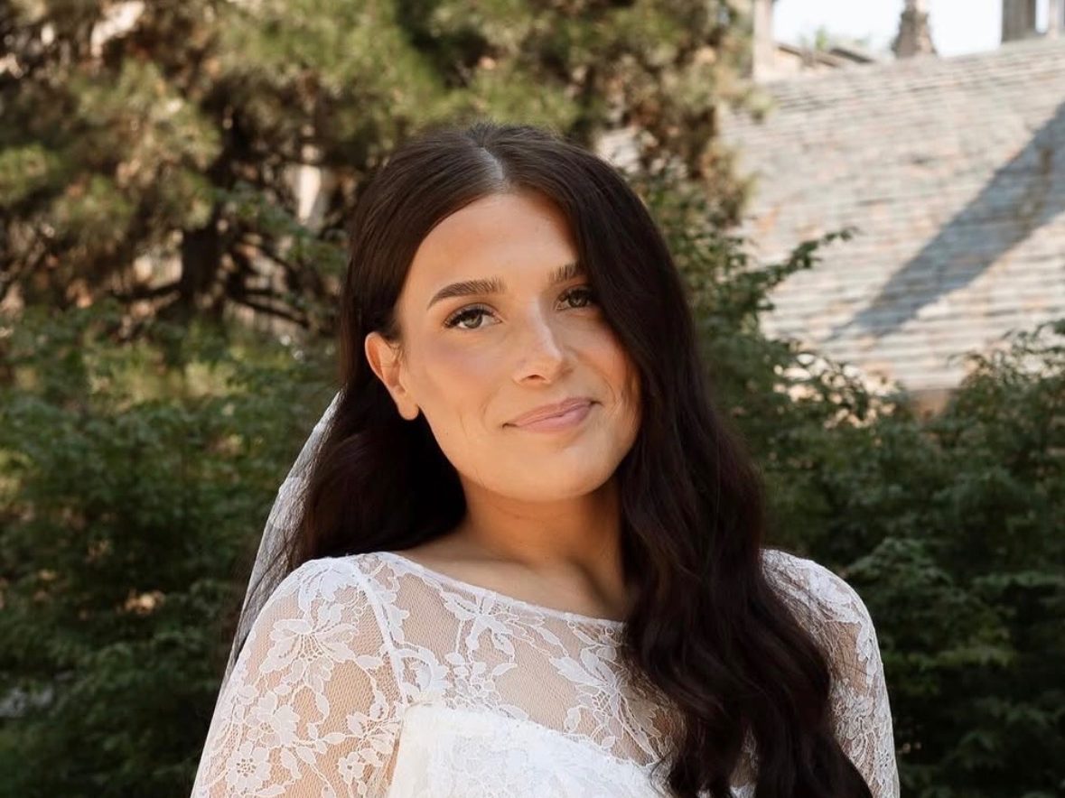 Samantha applying bridal makeup to a seated client — a full bridal session